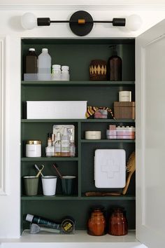 a green shelf filled with lots of different items