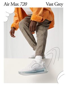 a man in an orange jacket is sitting on a white object with the words air max 70 vast grey above him