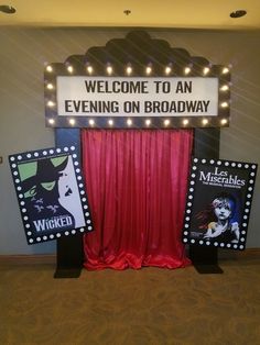 a sign that says, welcome to an evening on broadway with lights above the curtain