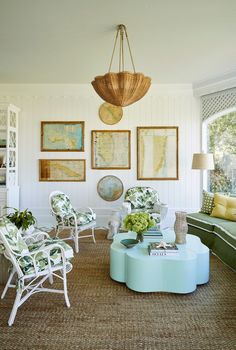 a living room filled with furniture and pictures on the wall