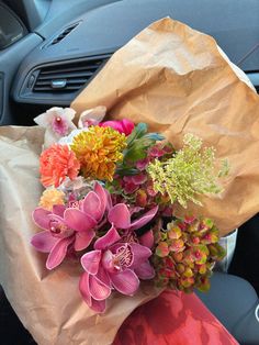 a bouquet of flowers sitting in the passenger seat of a car