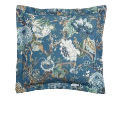 a blue floral pillow on a white background