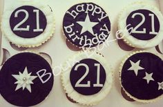 four decorated cookies in the shape of numbers and stars on a white box with black icing