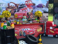 cars and trucks are on display in front of a booth at an amusement park for children