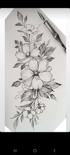 a pencil drawing of flowers and leaves on a sheet of paper with a pen next to it