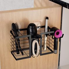 there is a metal holder with hair brushes and other items in it on the wall