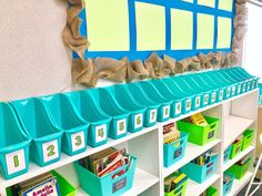 the shelves are organized with bins and baskets for books, snacks or other items