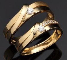 two gold rings with diamonds on them