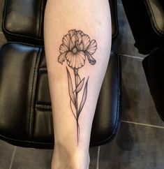 a woman's leg with a flower tattoo on it