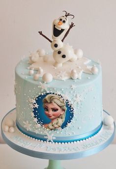 there is a cake decorated with an image of a frozen princess