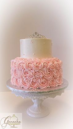 a cake with pink frosting and a tiara on top