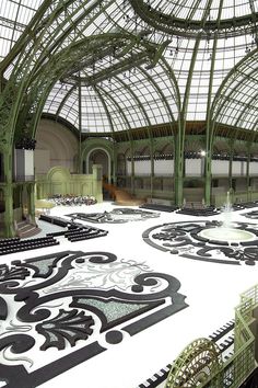 an elaborately designed building with lots of glass and metalwork on the ceiling is shown in this image