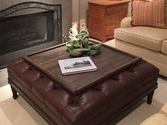 a living room with couches, chairs and a coffee table in front of a fireplace