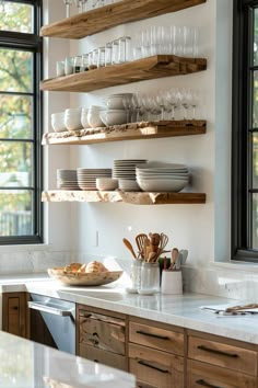 a kitchen with wooden shelves filled with dishes and glasses on top of the countertop