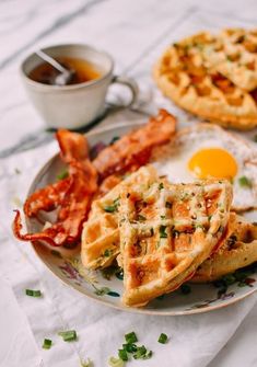 two waffles, bacon and eggs on a plate