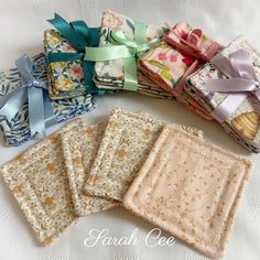 four folded fabric squares with bows on them