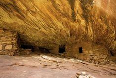 the interior of a cave with no people or animals in it and some rocks on the ground