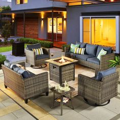 an outdoor living area with furniture and lighting