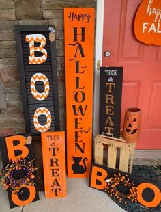 halloween decorations on the front steps of a house with pumpkins and boo's