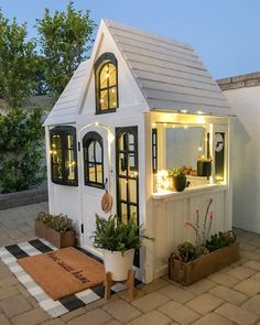 a small white house sitting on top of a patio