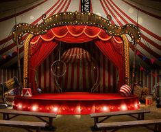 a red and white circus tent with lights