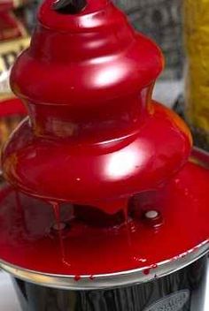 some strawberries are being poured into a juicer to make them look like they're falling