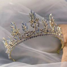 a gold tiara with crystal stones and leaves