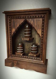 a wooden clock with two bells on it