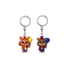 two key chains that are shaped to look like cartoon characters, one is holding a balloon and the other has a bear