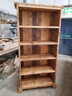 a wooden bookcase sitting inside of a building