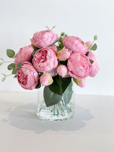 a vase filled with pink flowers on top of a table