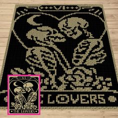 a black and white rug with the words lovers written on it, in front of a wooden