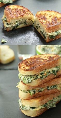 a stack of toasted sandwiches sitting on top of a table next to a glass of water