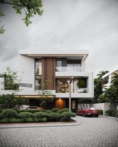 two cars parked in front of a modern house