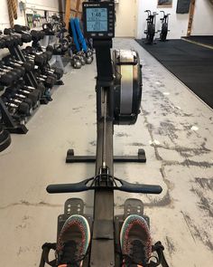 a pair of skis sitting on top of a machine in a room filled with exercise equipment