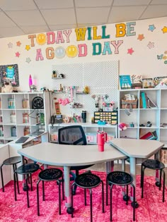 a classroom with desks and chairs in front of a sign that says today will be a good day