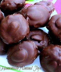 chocolate covered donuts sitting on top of a white plate