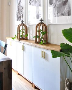 a dining room table with chairs and pictures on the wall