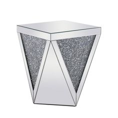 a mirrored side table with silver glitter in the shape of an inverted triangle, against a white background