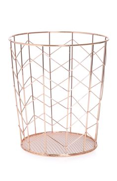 a metal wire basket with holes in it on a white background and the bottom is gold