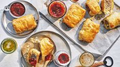 several pastries and condiments sit on plates next to some dipping sauces