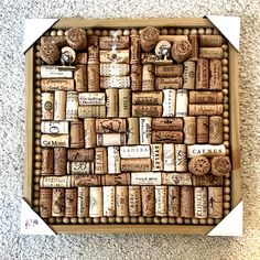 a box filled with lots of wine corks on top of a carpeted floor