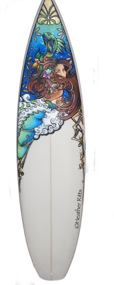 a white surfboard with an image of a mermaid on it's front end