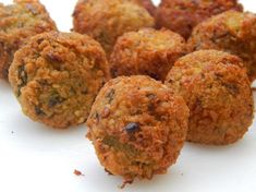 some meatballs are sitting on a white surface and ready to be eaten or eaten