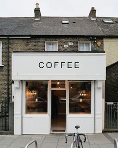 a bicycle parked in front of a coffee shop