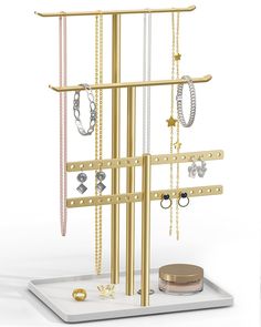 a gold jewelry rack with several different necklaces and rings on it's sides