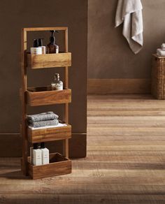 a wooden shelf with towels and soaps on it