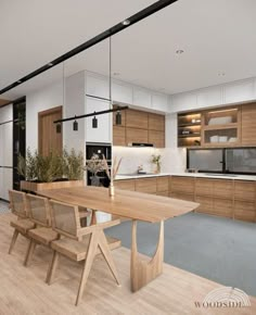 a modern kitchen with wooden cabinets and white walls, an island table surrounded by chairs