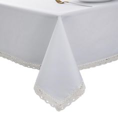 a white table cloth with lace trim on it and a plate next to it,