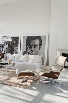 a living room filled with furniture and pictures on the wall